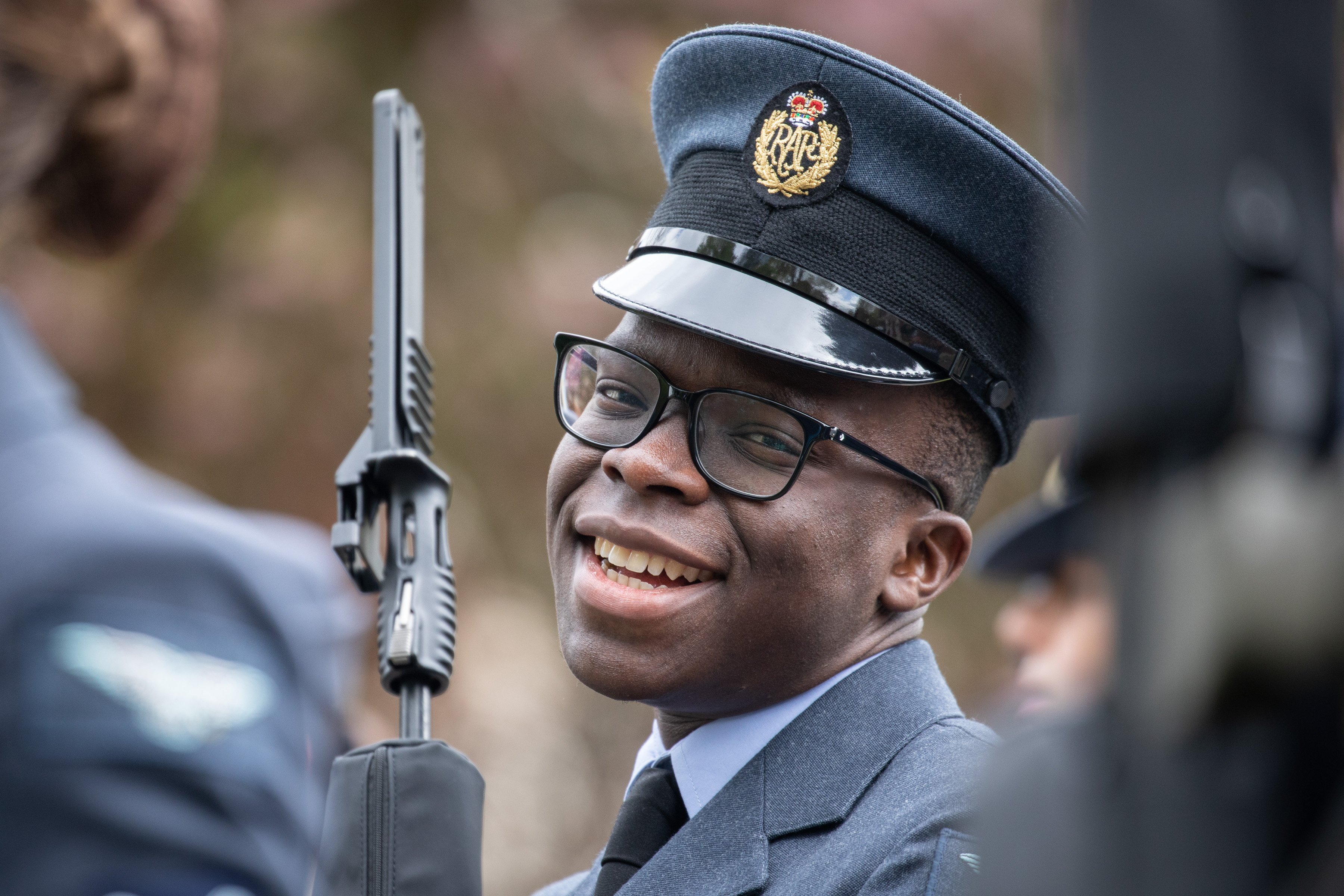 Personnel in parade with rifle.